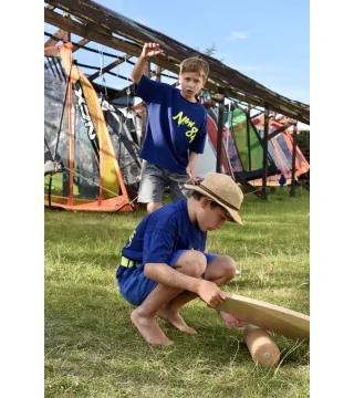 boy balancing on the grass on a  Wave balance board by NUKI